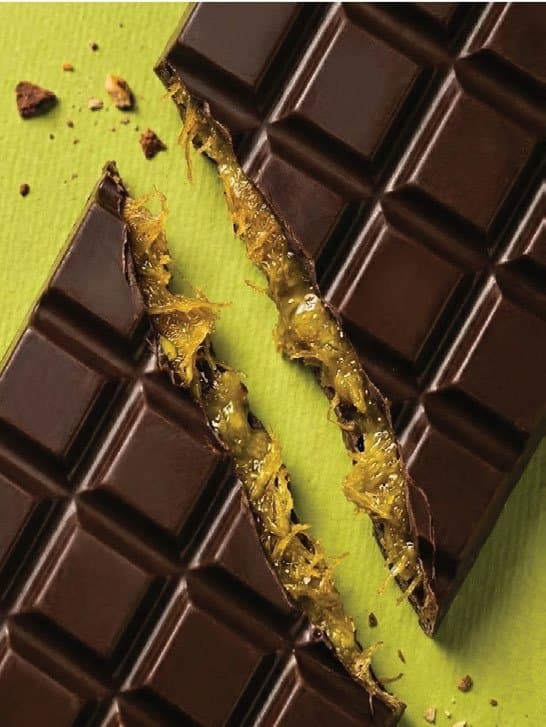 A chocolate bar broken open, revealing a citrus-marmalade filling
